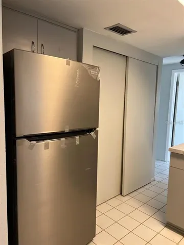 a white refrigerator freezer and sitting in a kitchen