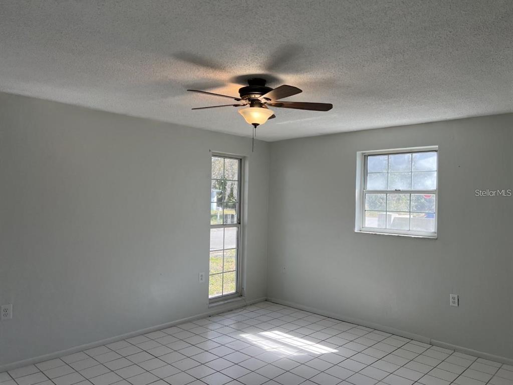 9011 St Clair Lane Port Richey, FL 34668 - Photo 9 of 20 a view of an empty room with a window