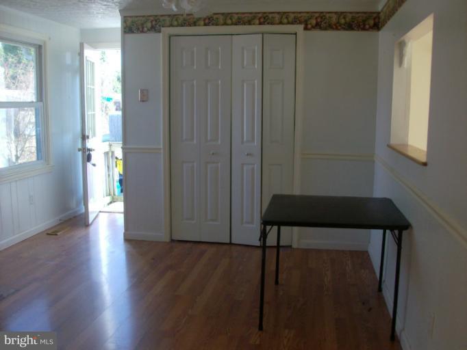 409 Circle Road Riva, MD 21140 - Photo 17 of 18 a view of a hallway with wooden floor and stairs