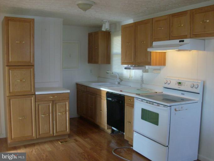 409 Circle Road Riva, MD 21140 - Photo 8 of 18 a kitchen with a sink stove and cabinets