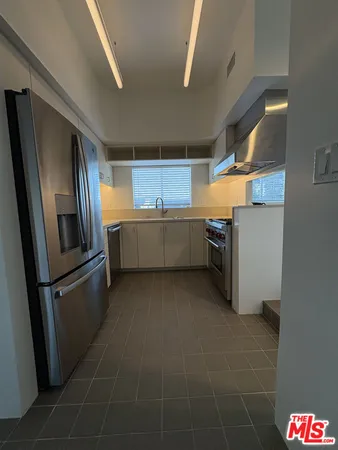 a kitchen with stainless steel appliances a refrigerator and a stove