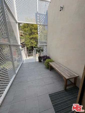 a balcony with chairs and table