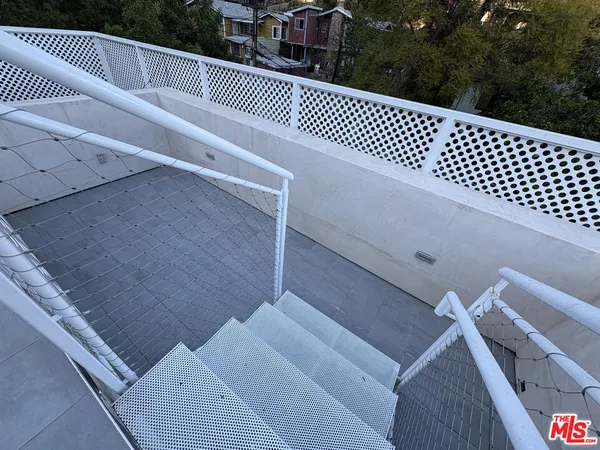 a view of a roof deck with wooden floor and fence