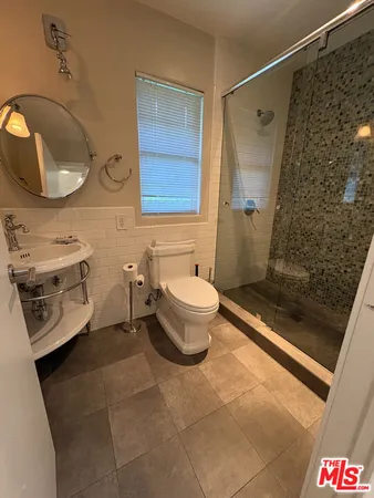 a bathroom with a sink mirror vanity and toilet