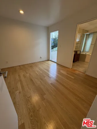 a view of an empty room and wooden floor