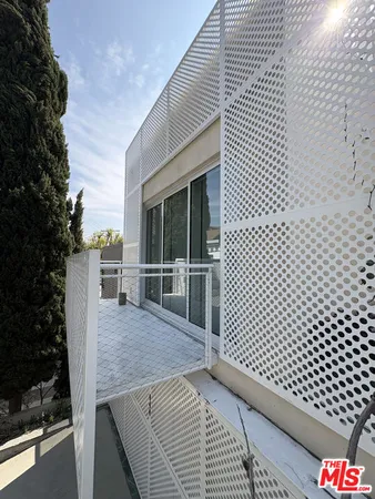 a view of a balcony with wooden floor and bench