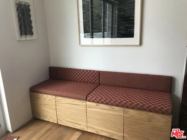 a view of bedroom with furniture and wooden floor