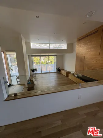 a kitchen with kitchen island granite countertop a sink and a large window