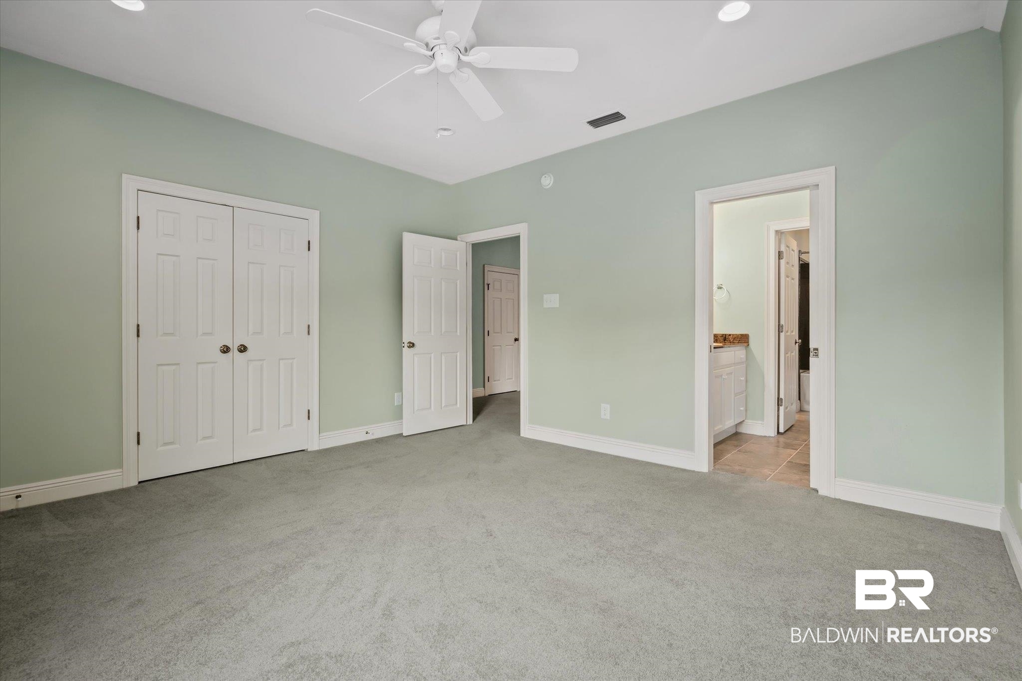 812 Country Club Court Mobile, AL 36609 - Photo 21 of 34 Unfurnished bedroom with a closet, ceiling fan, light colored carpet, and ensuite bathroom