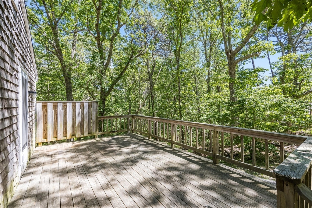 75 Cassick Valley Road, Unit B Wellfleet, MA 02667 - Photo 3 of 23 a view of a balcony with trees
