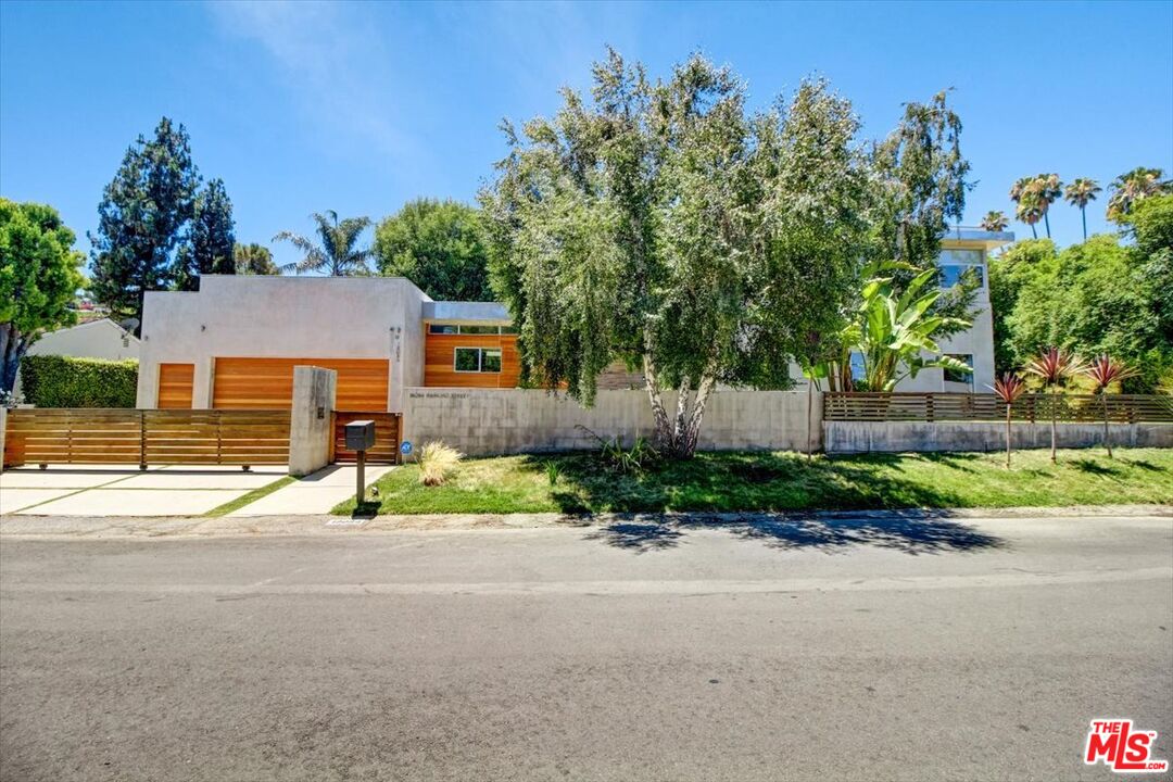 a front view of a house with a yard and a garage