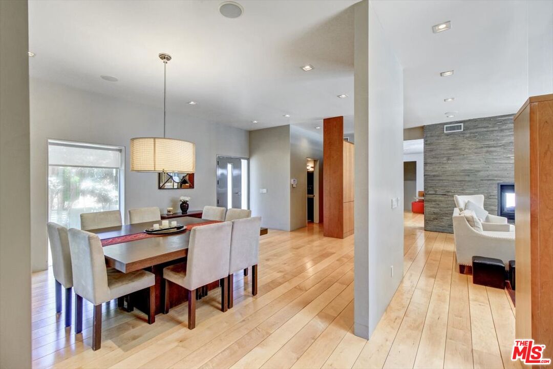 18084 Rancho Street Encino, CA 91316 - Photo 11 of 45 a dining room with a table and chairs