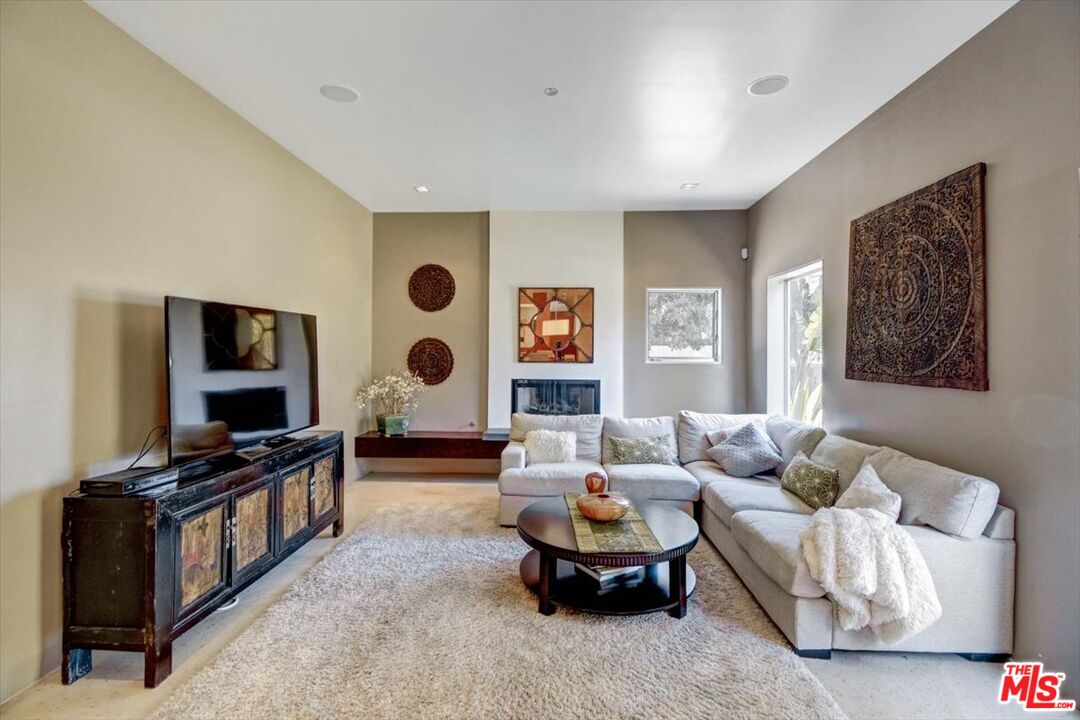 18084 Rancho Street Encino, CA 91316 - Photo 12 of 45 a living room with furniture and a flat screen tv
