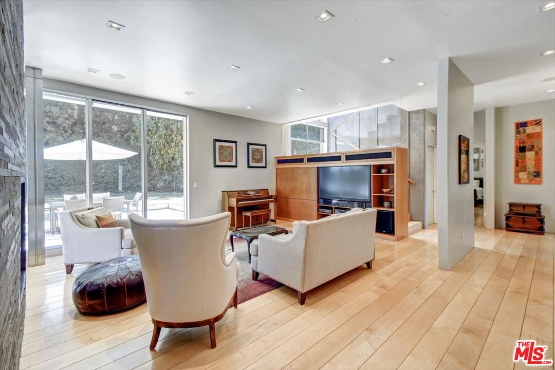 18084 Rancho Street Encino, CA 91316 - Photo 15 of 45 a living room with furniture and a flat screen tv