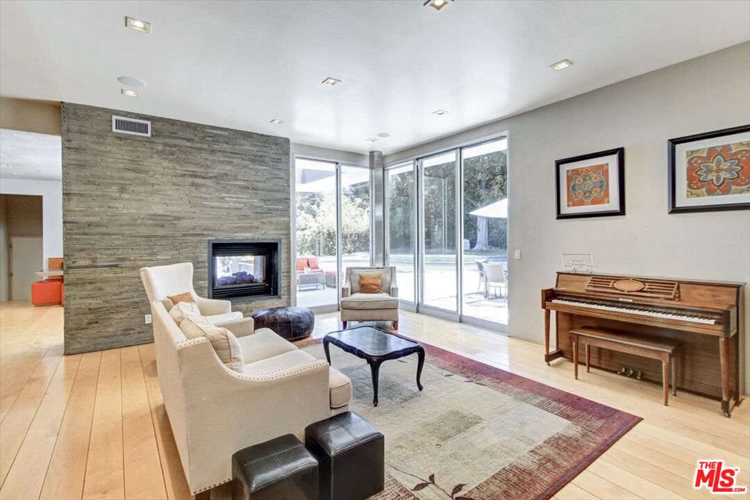 18084 Rancho Street Encino, CA 91316 - Photo 16 of 45 a living room with furniture and a fireplace