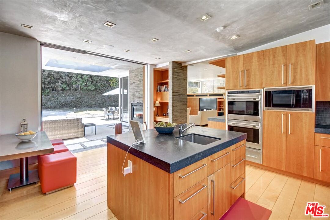 18084 Rancho Street Encino, CA 91316 - Photo 21 of 45 a kitchen with stainless steel appliances granite countertop a sink a stove and a refrigerator