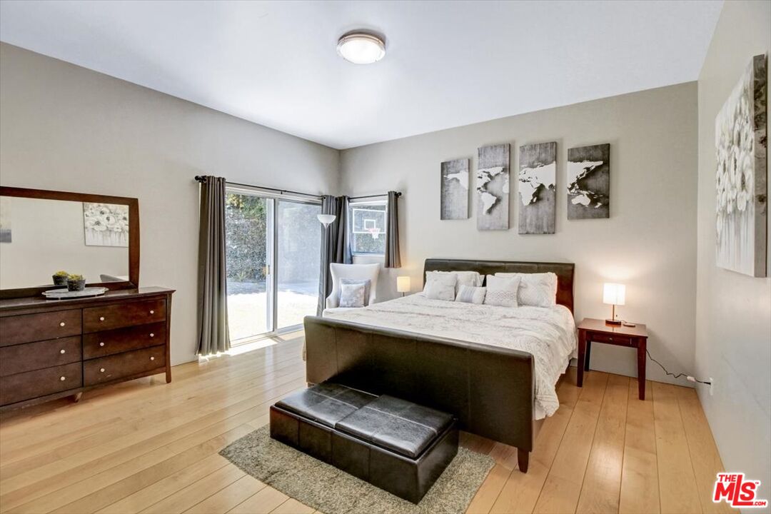 18084 Rancho Street Encino, CA 91316 - Photo 22 of 45 a bedroom with a bed and a dresser in it