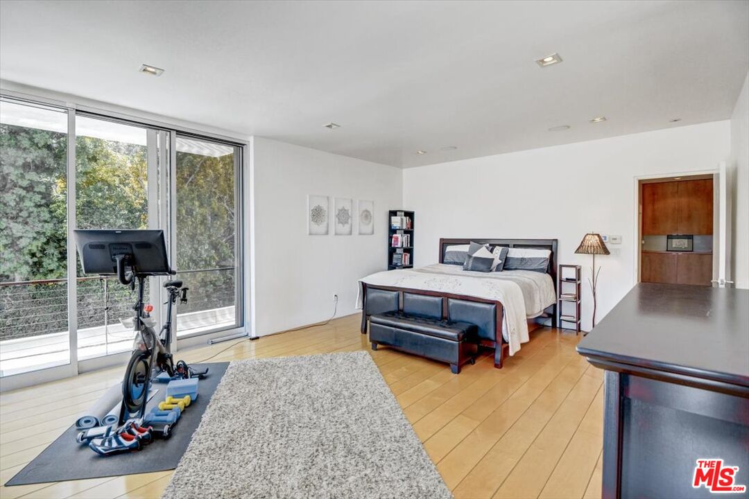 18084 Rancho Street Encino, CA 91316 - Photo 27 of 45 a bedroom with a bed a dresser and a large window