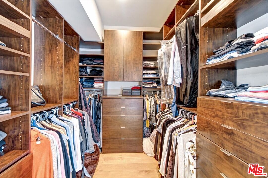18084 Rancho Street Encino, CA 91316 - Photo 28 of 45 a view of walk in closet with clothes and shoes
