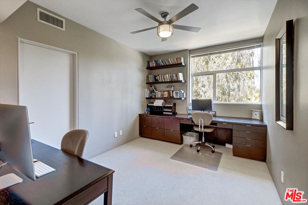 18084 Rancho Street Encino, CA 91316 - Photo 32 of 45 a workspace with furniture and a window
