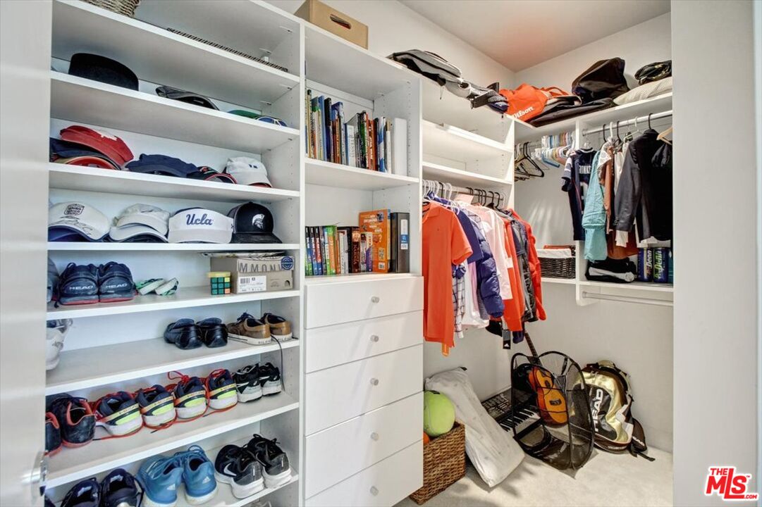 18084 Rancho Street Encino, CA 91316 - Photo 34 of 45 a view of walk in closet with clothes and shoes