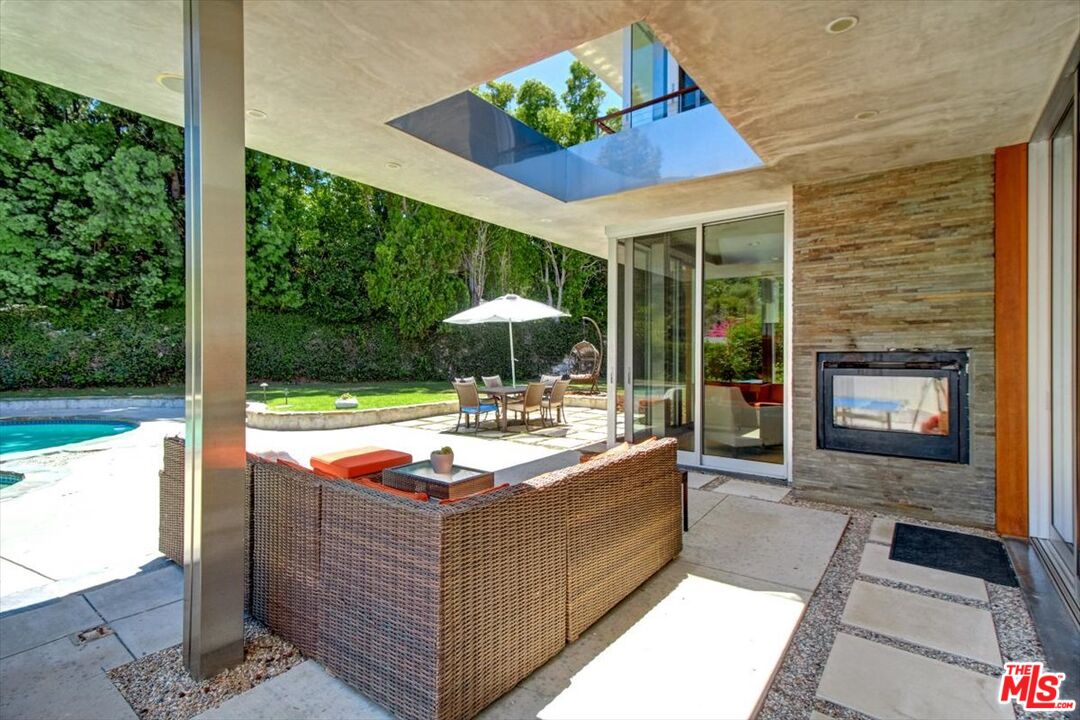18084 Rancho Street Encino, CA 91316 - Photo 40 of 45 a outdoor space with patio the couches and a fireplace