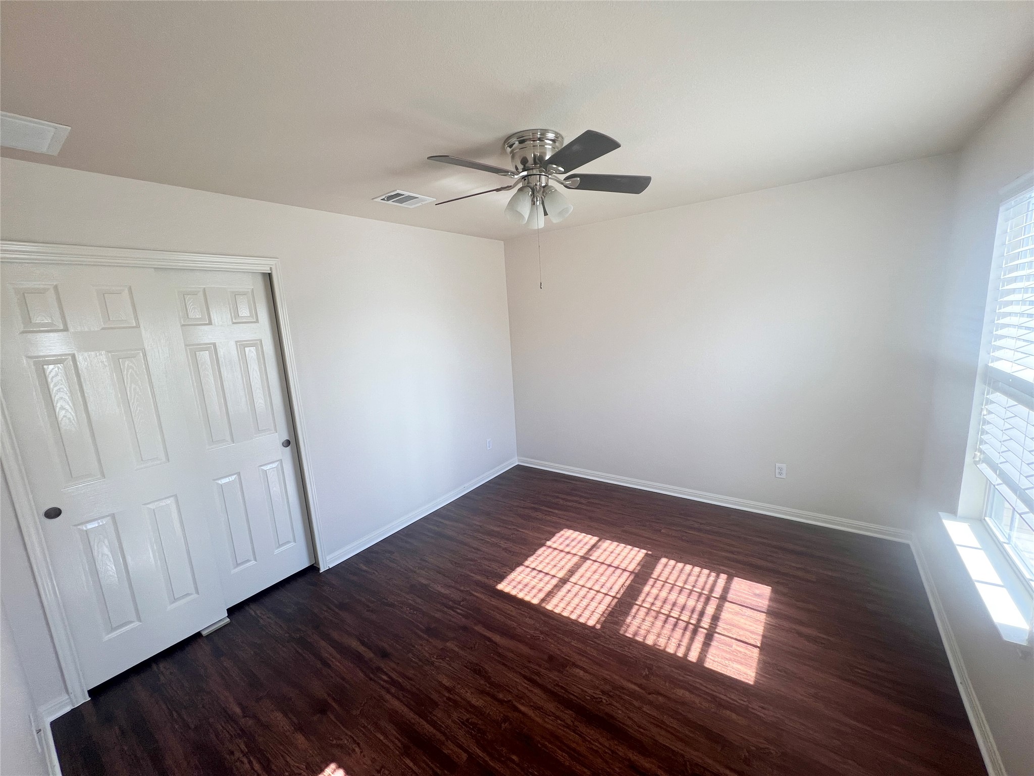 476 Nottingham Loop Kyle, TX 78640 - Photo 12 of 29 wooden floor in an empty room with a window