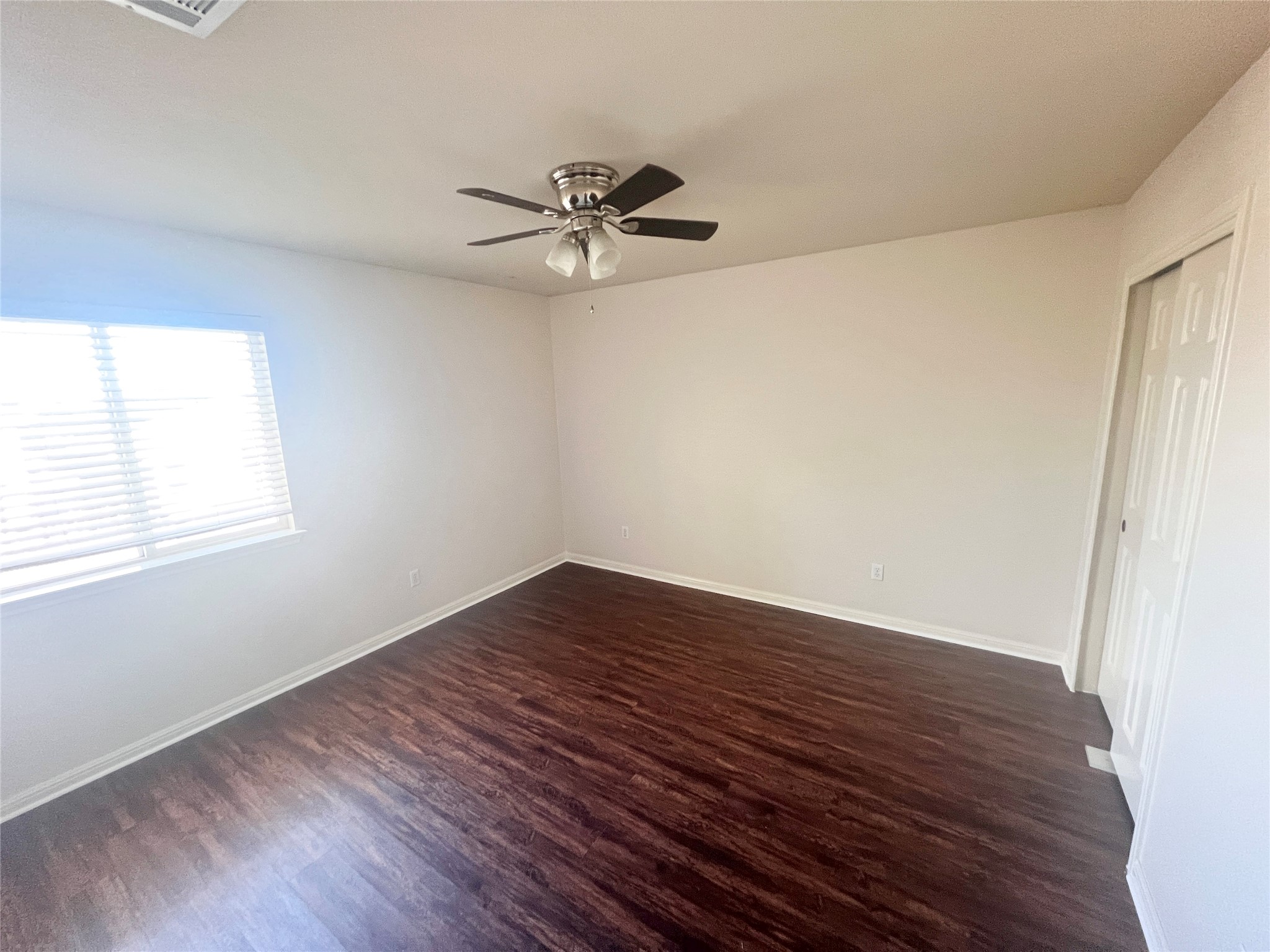 476 Nottingham Loop Kyle, TX 78640 - Photo 15 of 29 an empty room with wooden floor fan and windows