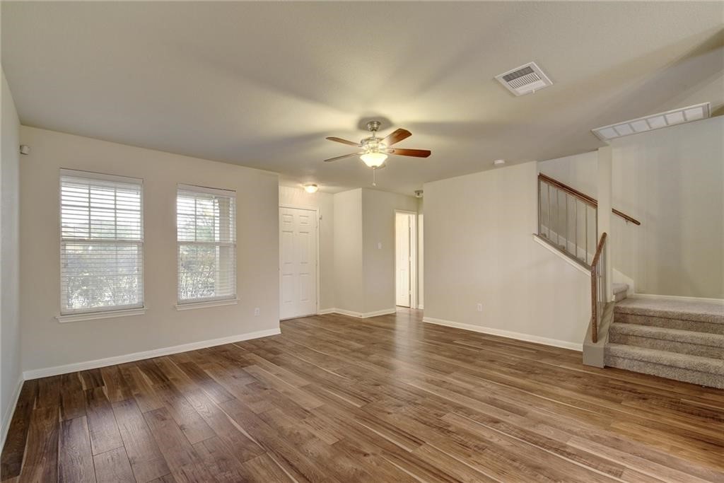 476 Nottingham Loop Kyle, TX 78640 - Photo 2 of 29 a view of an empty room with wooden floor and a window