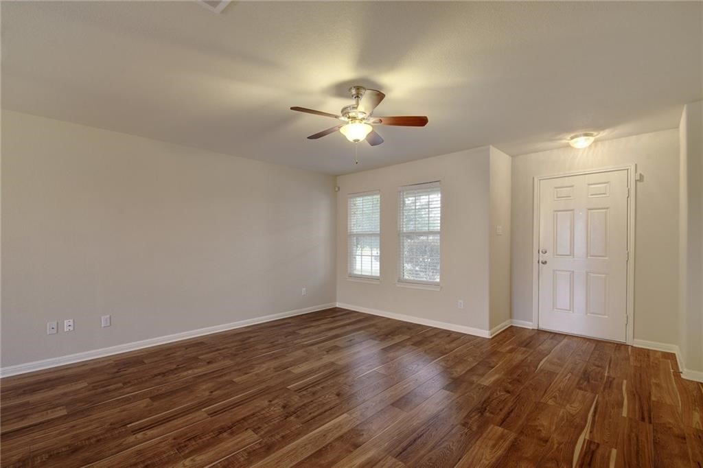 476 Nottingham Loop Kyle, TX 78640 - Photo 3 of 29 a view of a room with wooden floor and a ceiling fan