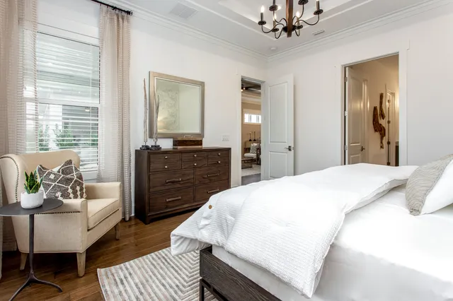 a bedroom with a bed a couch and dresser