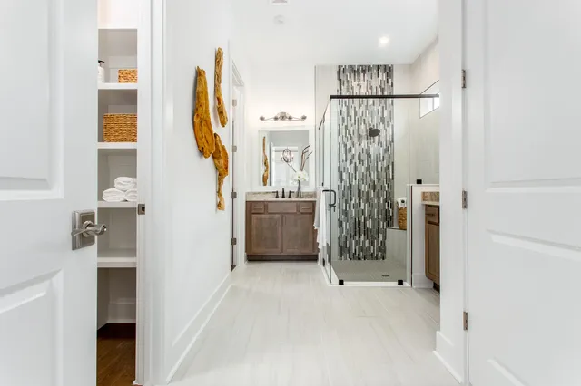 a view of a bathroom with sink mirror and shower