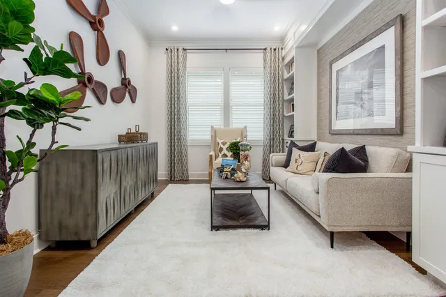 a living room with furniture and a book shelf
