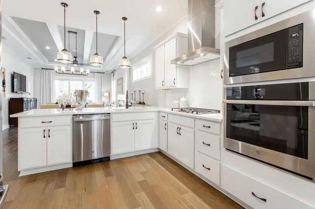 a kitchen with a white stove cabinets and a wooden floor