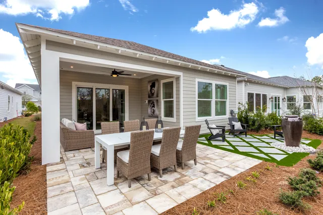 a view of a patio with table and chairs and potted plants