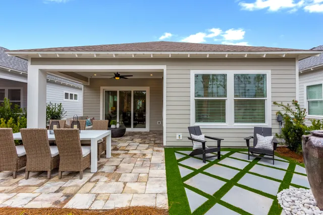 a view of a house with backyard sitting area and garden