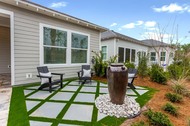 a view of a house with backyard sitting area and garden