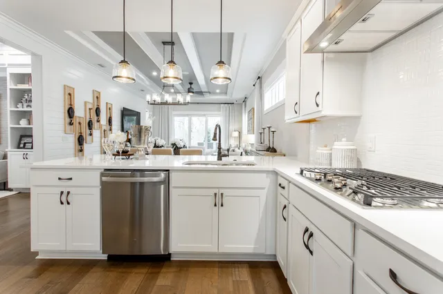 a kitchen with stainless steel appliances granite countertop a sink stove and cabinets
