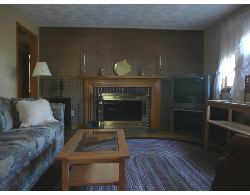 14 Roman Road Woburn, MA 01801 - Photo 3 of 14 a living room with furniture and a fireplace