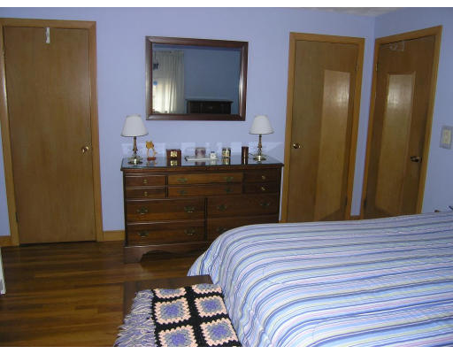14 Roman Road Woburn, MA 01801 - Photo 8 of 14 a bedroom with a bed and a flat tv screen on dresser