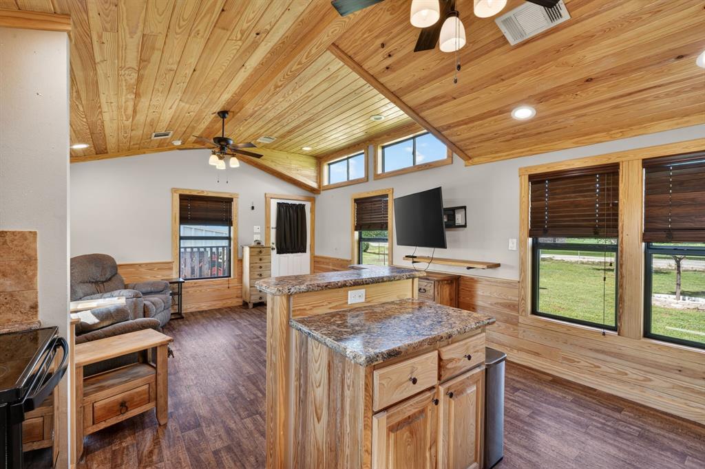 2401 Lamkin Road Mineral Wells, TX 76067 - Photo 12 of 36 a kitchen with a stove and a wooden floor