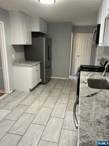 a kitchen with a sink a stove and refrigerator