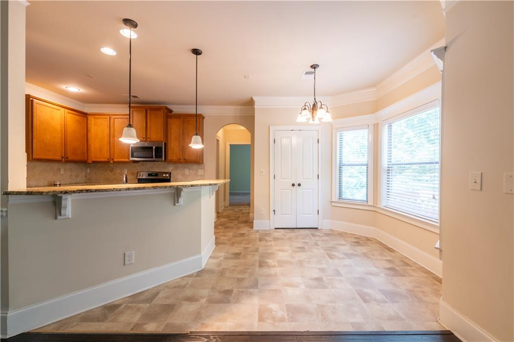 1412 Turnbridge Walk Hampton, GA 30228 - Photo 11 of 40 a kitchen that has a lot of cabinets and a wooden floor