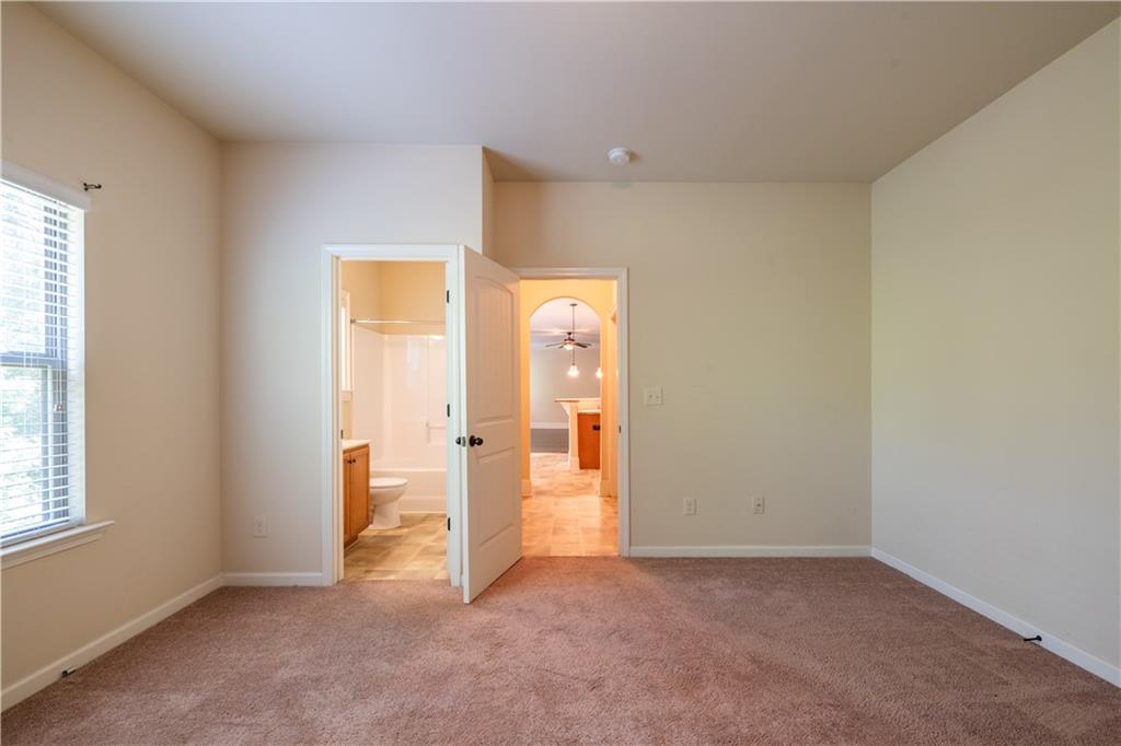 1412 Turnbridge Walk Hampton, GA 30228 - Photo 19 of 40 an empty room with windows and closet