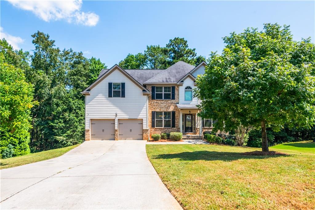 1412 Turnbridge Walk Hampton, GA 30228 - Photo 2 of 40 a front view of house with yard and green space