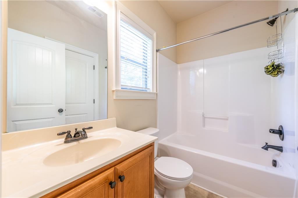 1412 Turnbridge Walk Hampton, GA 30228 - Photo 21 of 40 a bathroom with a sink a toilet and a bathtub