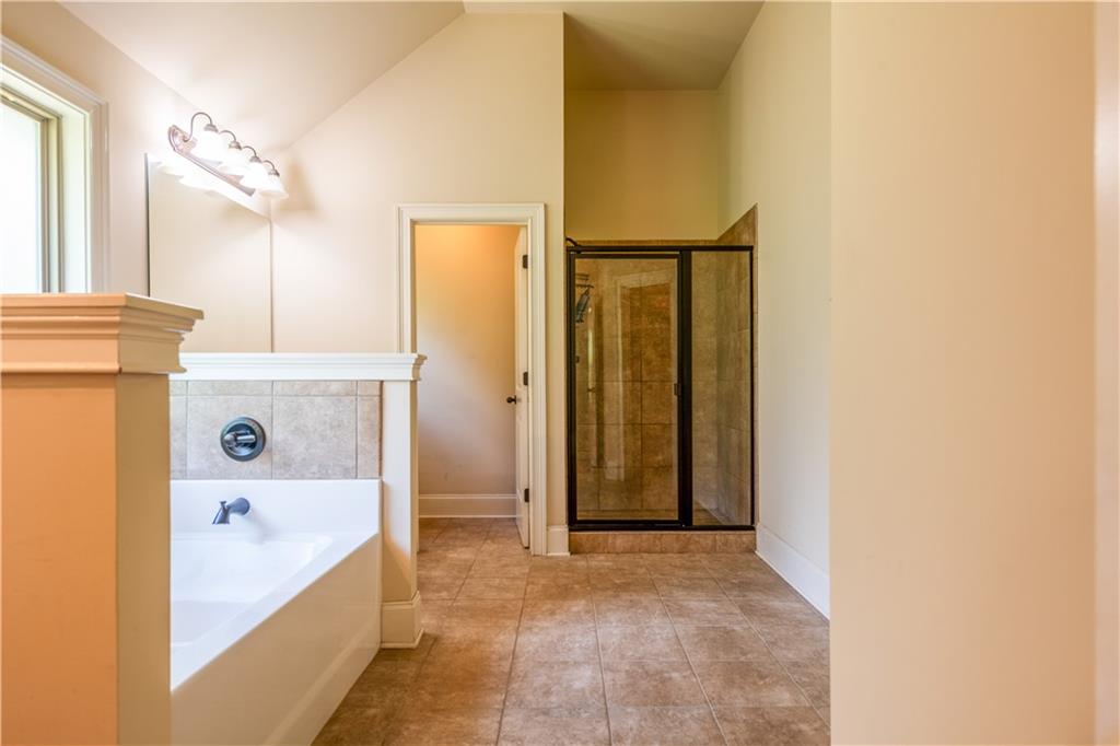 1412 Turnbridge Walk Hampton, GA 30228 - Photo 24 of 40 a bathroom with a bathtub and a shower