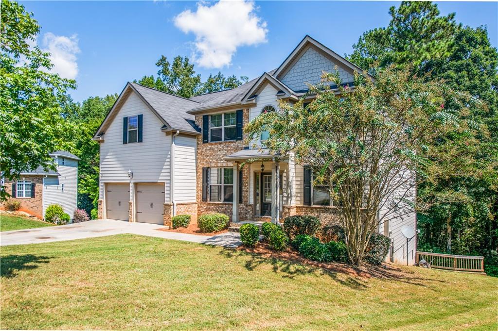 1412 Turnbridge Walk Hampton, GA 30228 - Photo 3 of 40 a house view with a garden space