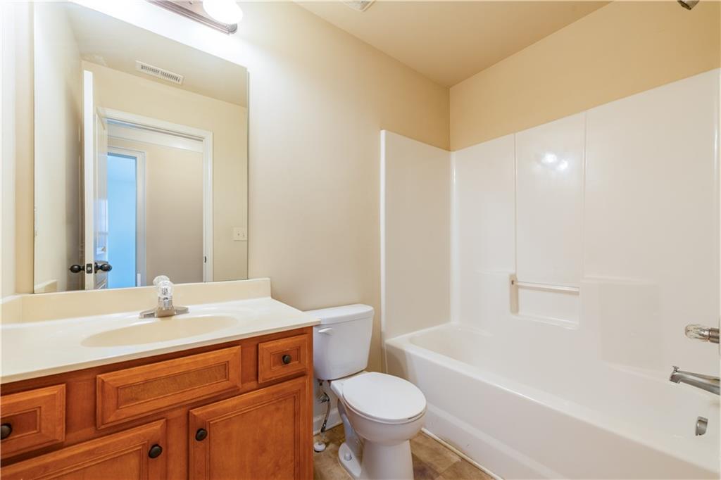 1412 Turnbridge Walk Hampton, GA 30228 - Photo 31 of 40 a bathroom with a sink toilet vanity and bathtub