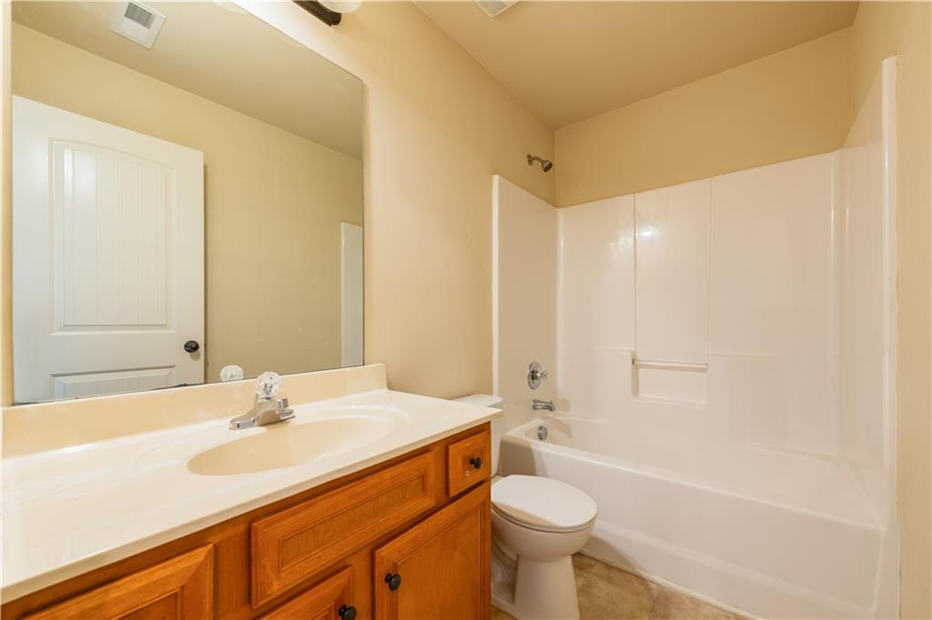 1412 Turnbridge Walk Hampton, GA 30228 - Photo 34 of 40 a bathroom with a sink a toilet and shower